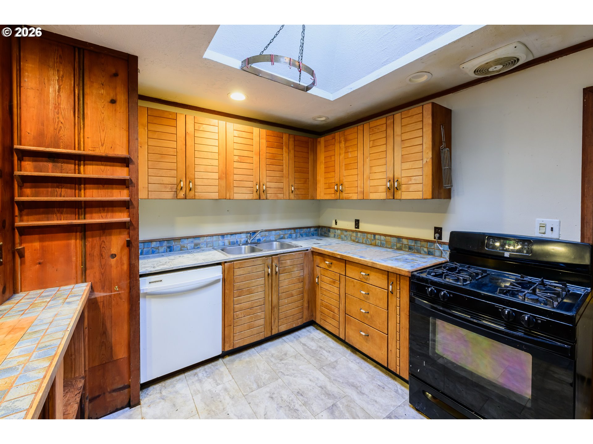 1377 Moonshine Park Road Logsden, OR 97357 - Photo 18 of 40 a kitchen with stainless steel appliances granite countertop stove a sink and a microwave
