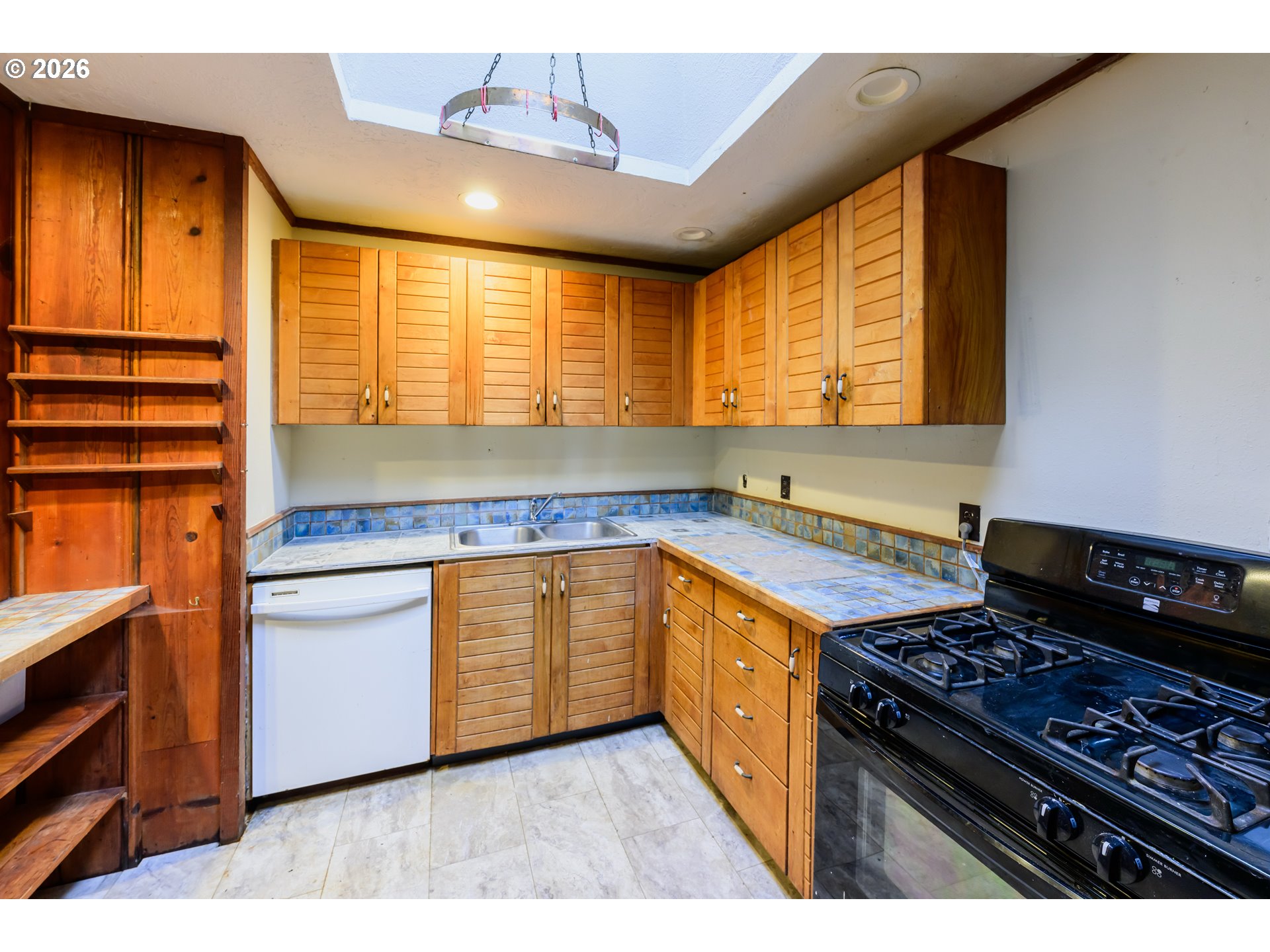 1377 Moonshine Park Road Logsden, OR 97357 - Photo 19 of 40 a kitchen with stainless steel appliances granite countertop a stove a sink and a microwave
