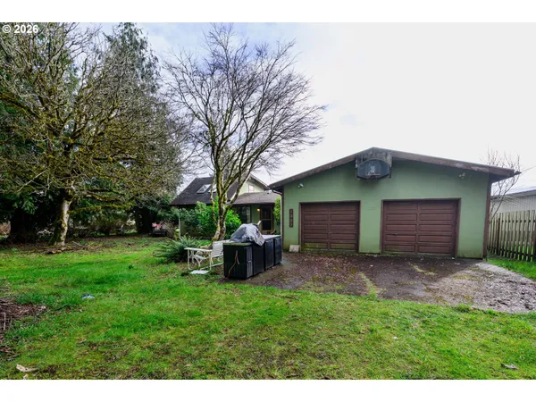 a backyard of a house with outdoor seating and barbeque oven