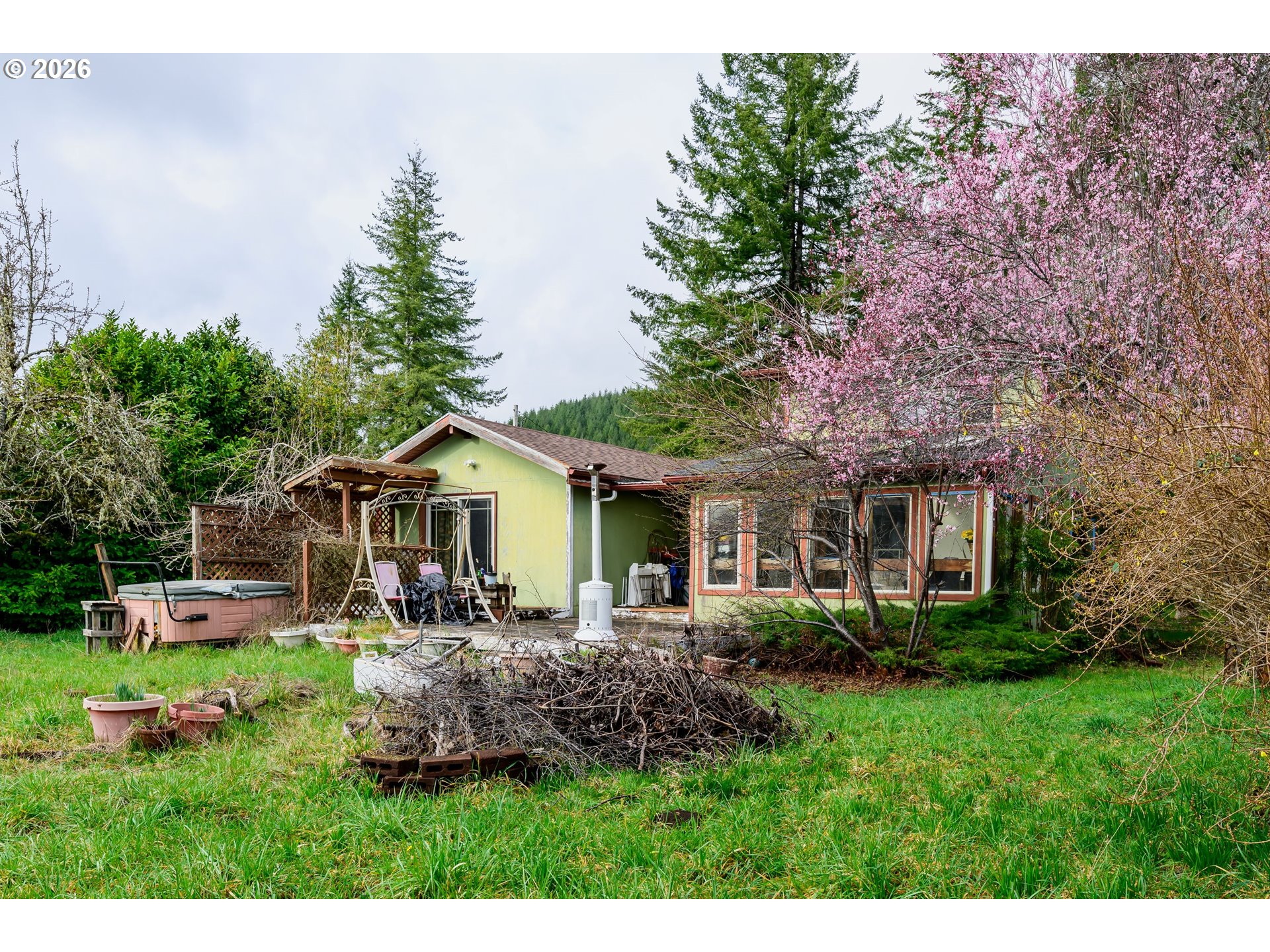 1377 Moonshine Park Road Logsden, OR 97357 - Photo 39 of 40 a front view of house with a garden and trees