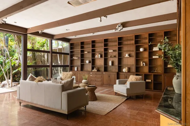 a living room with a couch and a shelf