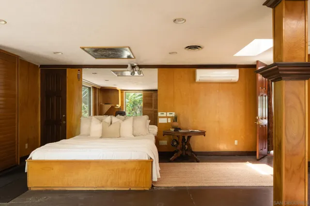 a bedroom with a bed and a window