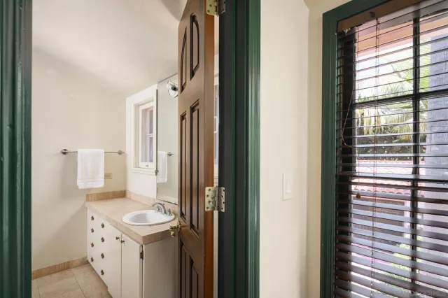 a view of house with swimming pool and a yard