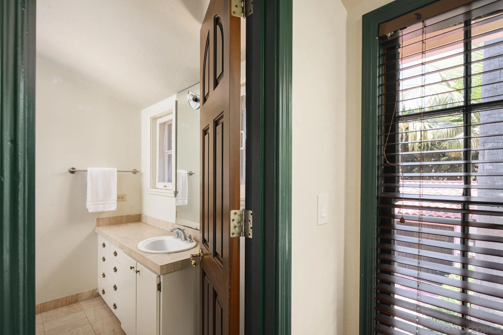 1010 Myrtle Way San Diego, CA 92103 - Photo 35 of 70 a bathroom with a sink a toilet and a mirror