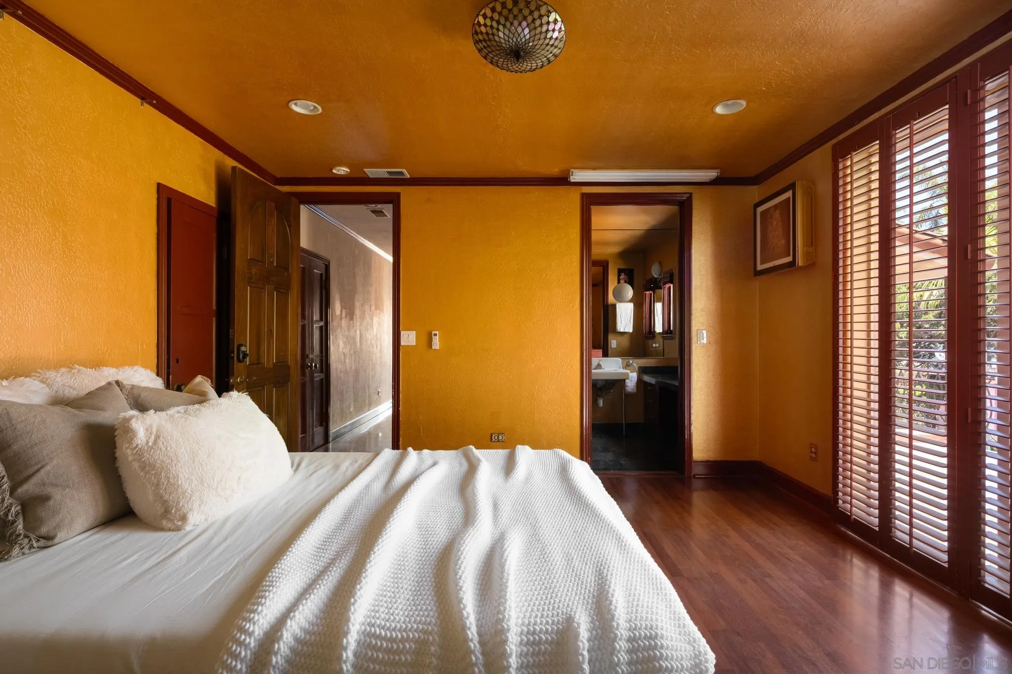 1010 Myrtle Way San Diego, CA 92103 - Photo 36 of 70 a bedroom with a large bed and wooden floor