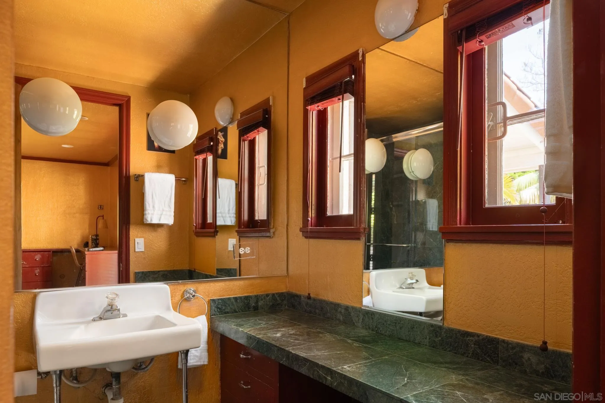 1010 Myrtle Way San Diego, CA 92103 - Photo 37 of 70 a bathroom with a sink and a mirror