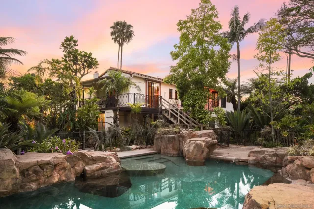 a green field with lots of trees