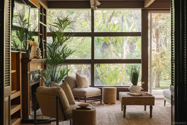 a living room with furniture and large windows