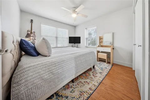 a bedroom with a large bed and a tv