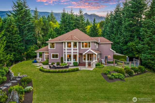 a front view of a house with a yard table and chairs