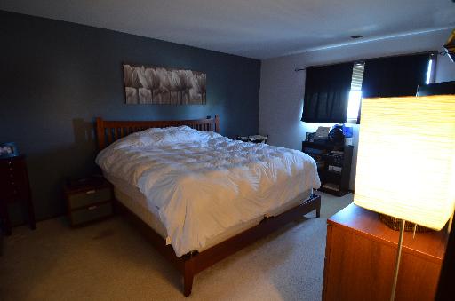 10643 Major Avenue, Unit 3D Chicago Ridge, IL 60415 - Photo 5 of 8 a bed sitting in a bedroom next to a window