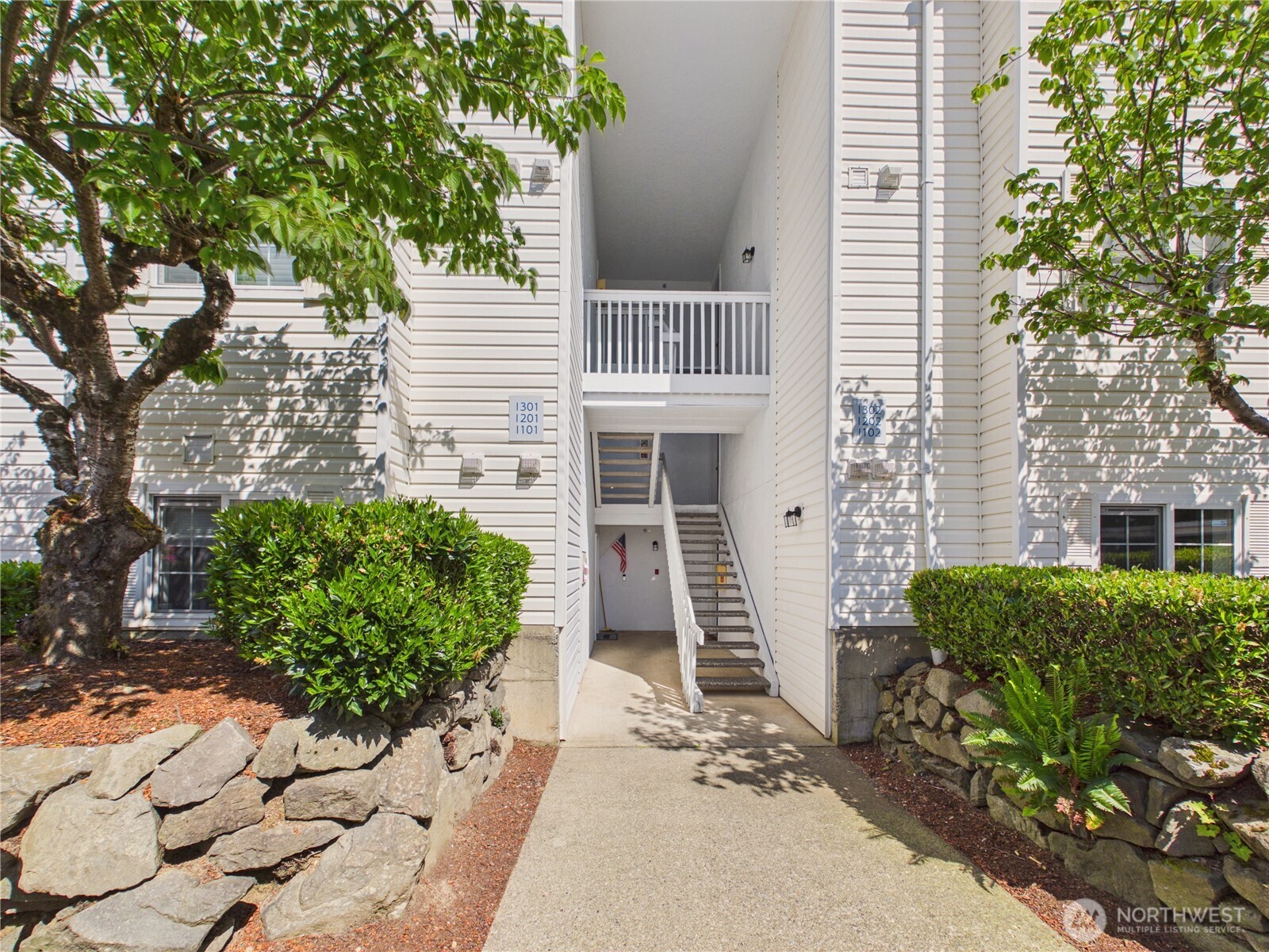 11002 Southeast Petrovitsky Road, Unit I102 Renton, WA 98055 - Photo 1 of 24 a front view of a house with a yard