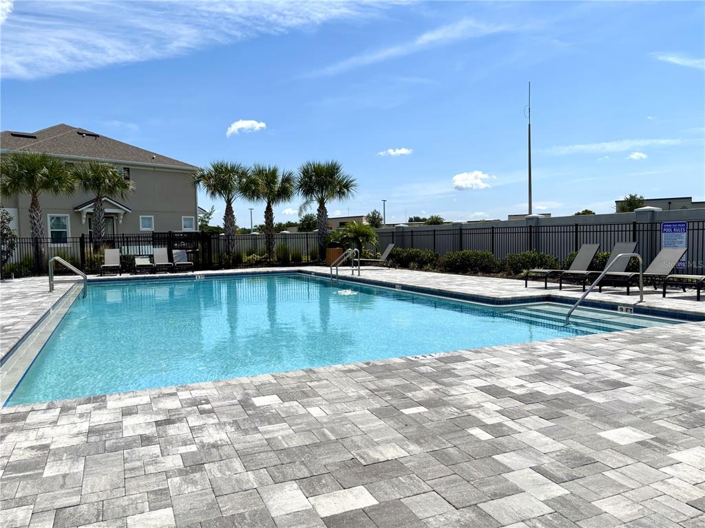 921 Spring Palms Loop Orlando, FL 32828 - Photo 12 of 30 a view of a swimming pool with a patio