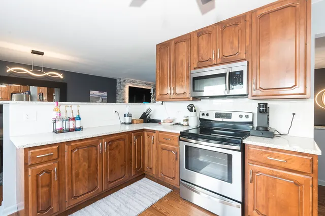 a kitchen with stainless steel appliances a stove microwave and cabinets