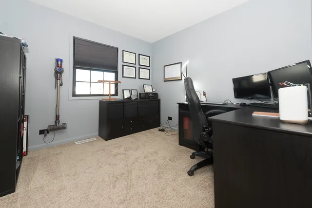 a view of empty room with fireplace and cabinet