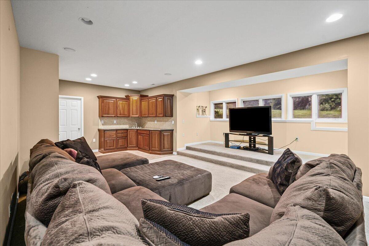 8751 Bridgewater Court Crown Point, IN 46307 - Photo 43 of 49 a living room with furniture and a flat screen tv