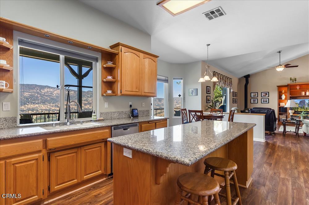 30730 Fox Ridge Court Tehachapi, CA 93561 - Photo 18 of 61 a large kitchen with granite countertop a sink and cabinets with wooden floor