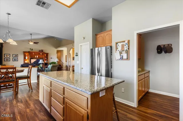 a kitchen with stainless steel appliances granite countertop a refrigerator stove microwave and sink