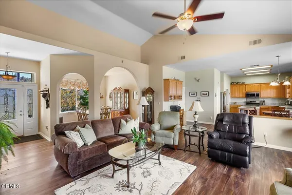 a living room with furniture fireplace and a large window