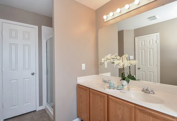 a bathroom with a sink vanity and a mirror