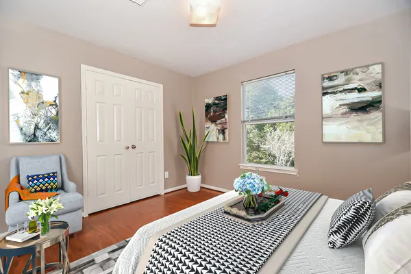 a bedroom with a bed and a window