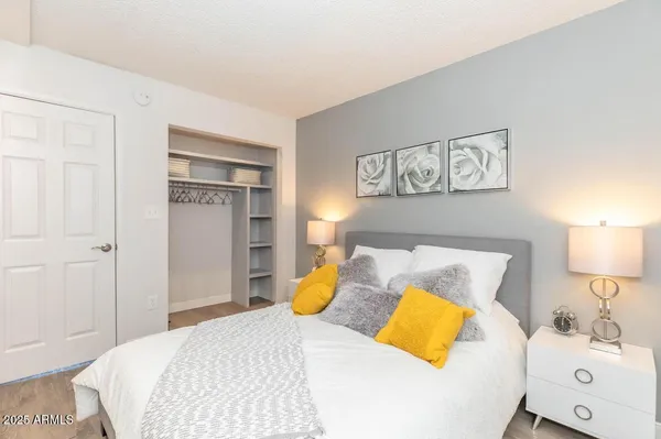 a bedroom with a bed and a lamp