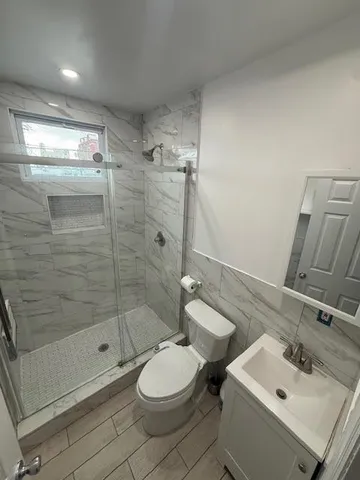 a bathroom with a sink toilet and shower
