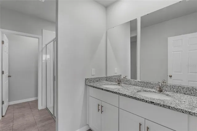 a bathroom with a glass shower door