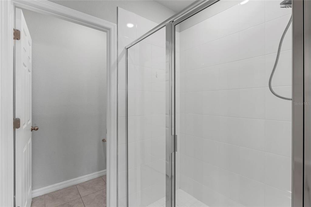 3472 Monaco Drive Davenport, FL 33897 - Photo 14 of 25 a bathroom with a glass shower door
