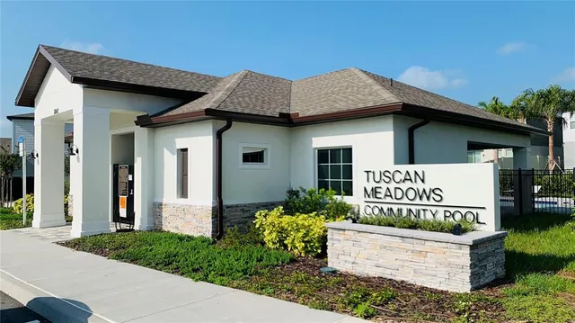 a dining room with furniture and a large window