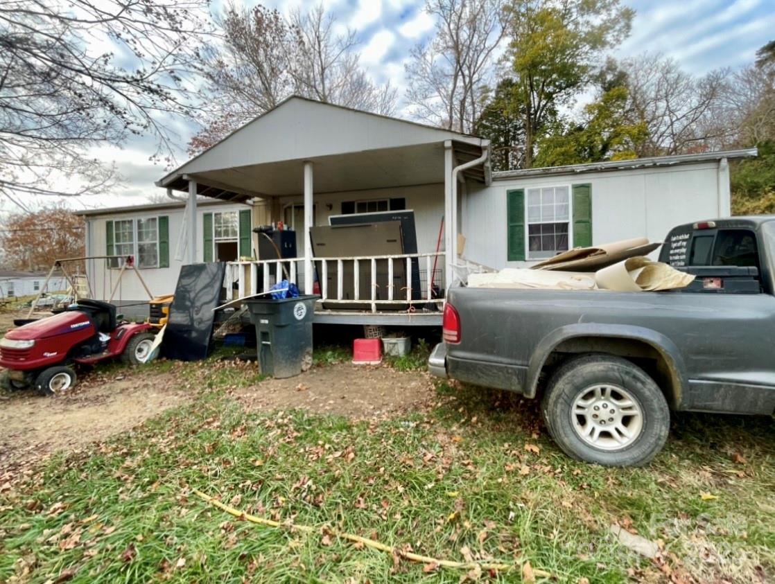 131 Lookout Road Asheville, NC 28804 - Photo 6 of 10 a front view of a house with a garden and parking space