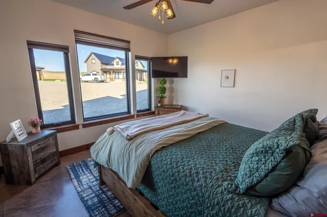 a bedroom with a bed and a mirror