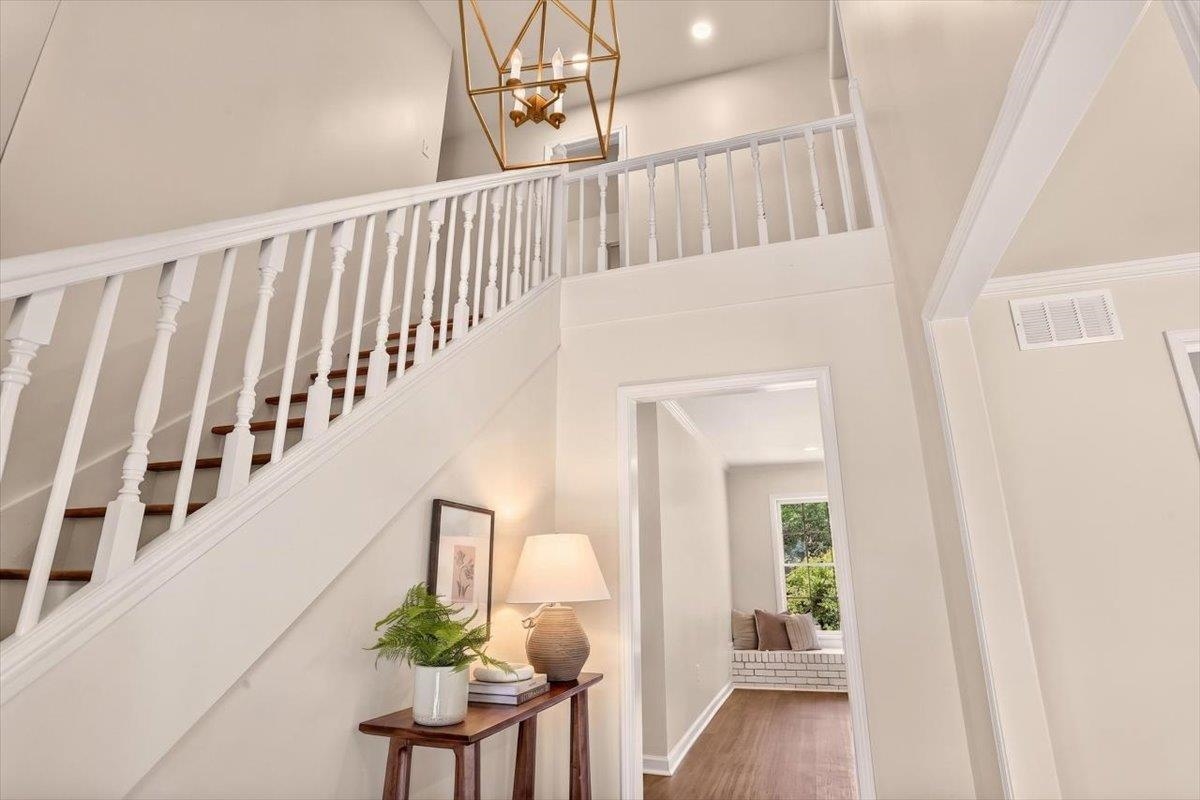 7674 Apple Valley Road Germantown, TN 38138 - Photo 6 of 15 Two-story entry with a white balustrade staircase featuring wood-finish treads, a gold-toned geometric chandelier, and recessed lighting
