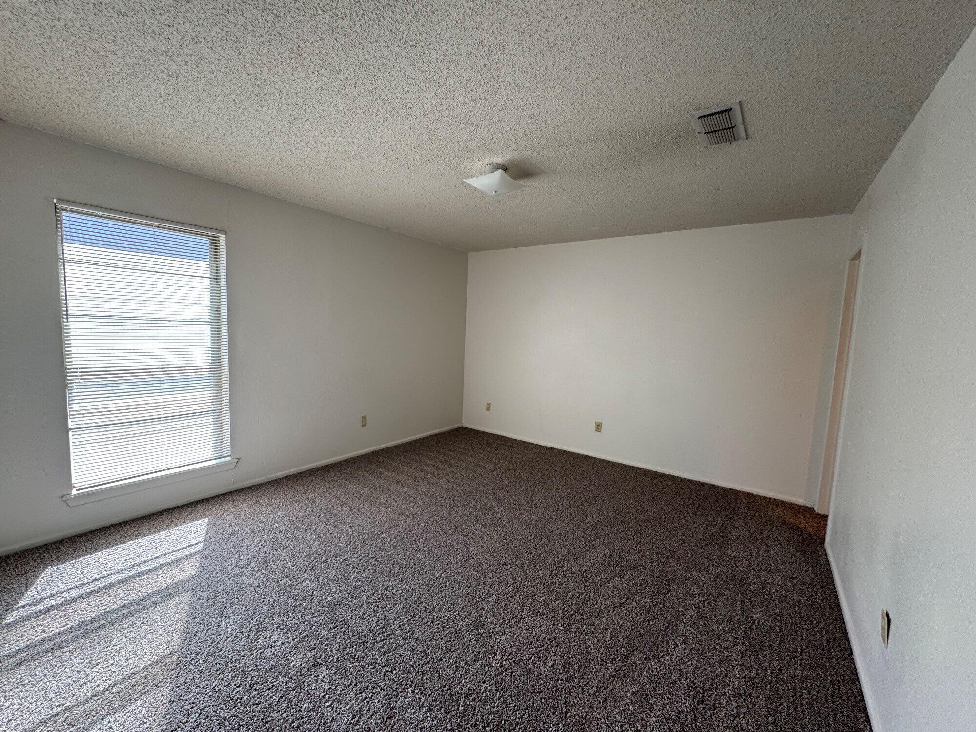7403 Utica Avenue, Unit B Lubbock, TX 79424 - Photo 7 of 9 a view of a room that has a window in it