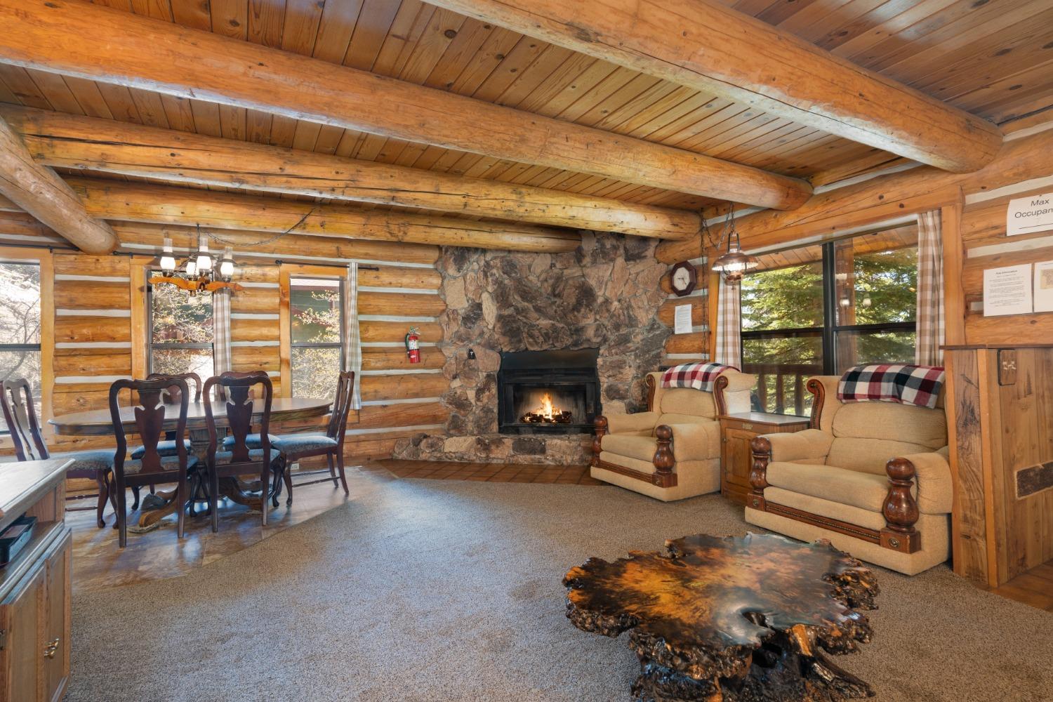 7426 Henness Ridge Road Yosemite West, CA 95389 - Photo 11 of 35 Corner fireplace (wood-burning) is visible from living room, dining area, and kitchen.