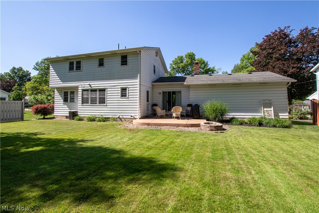 910 Andrews Road Medina, OH 44256 - Photo 37 of 45 Back of property featuring a patio, an outdoor fire pit, and a lawn