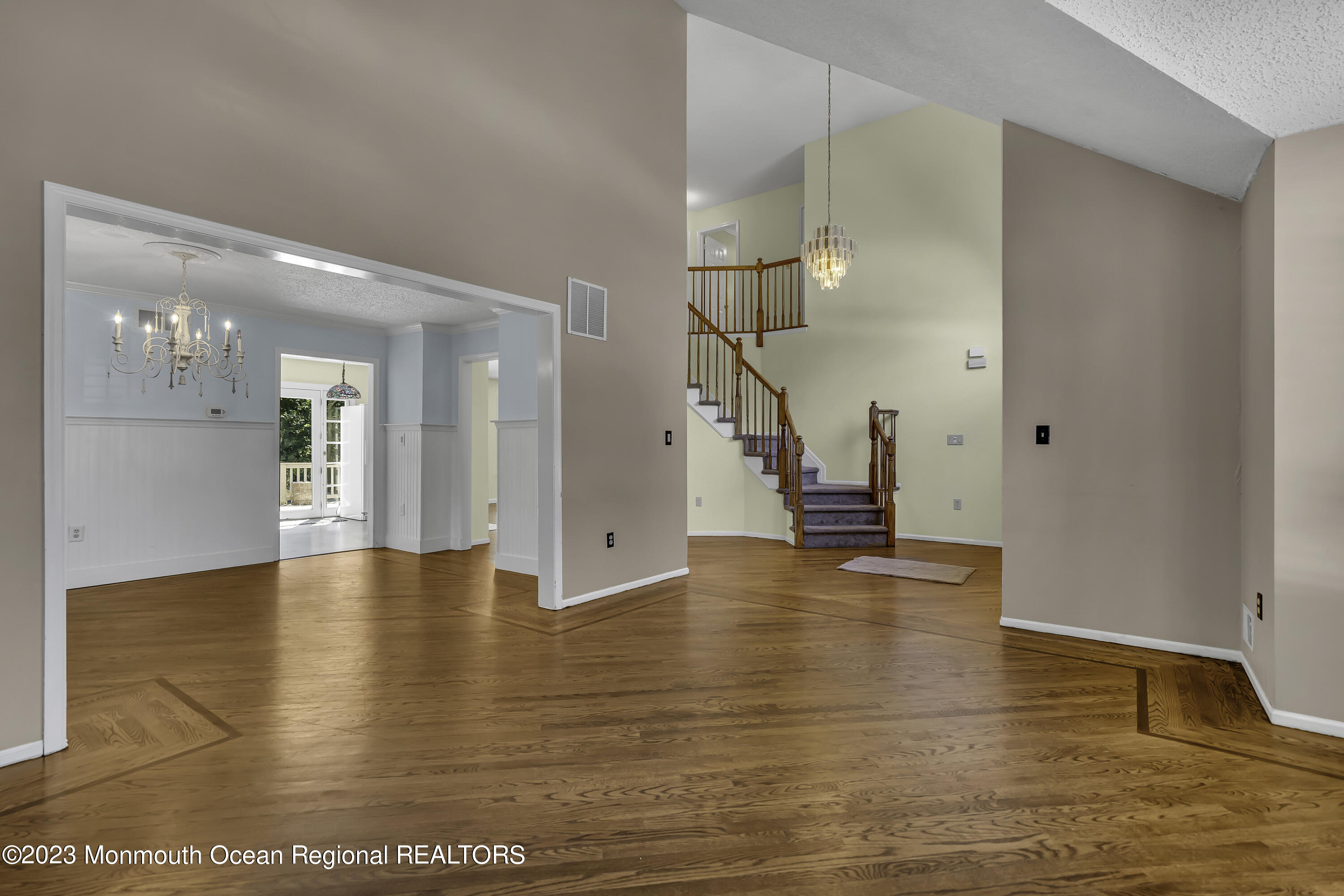 244 Down Hill Run Toms River, NJ 08755 - Photo 13 of 44 a view of an empty room with wooden floor and a kitchen view