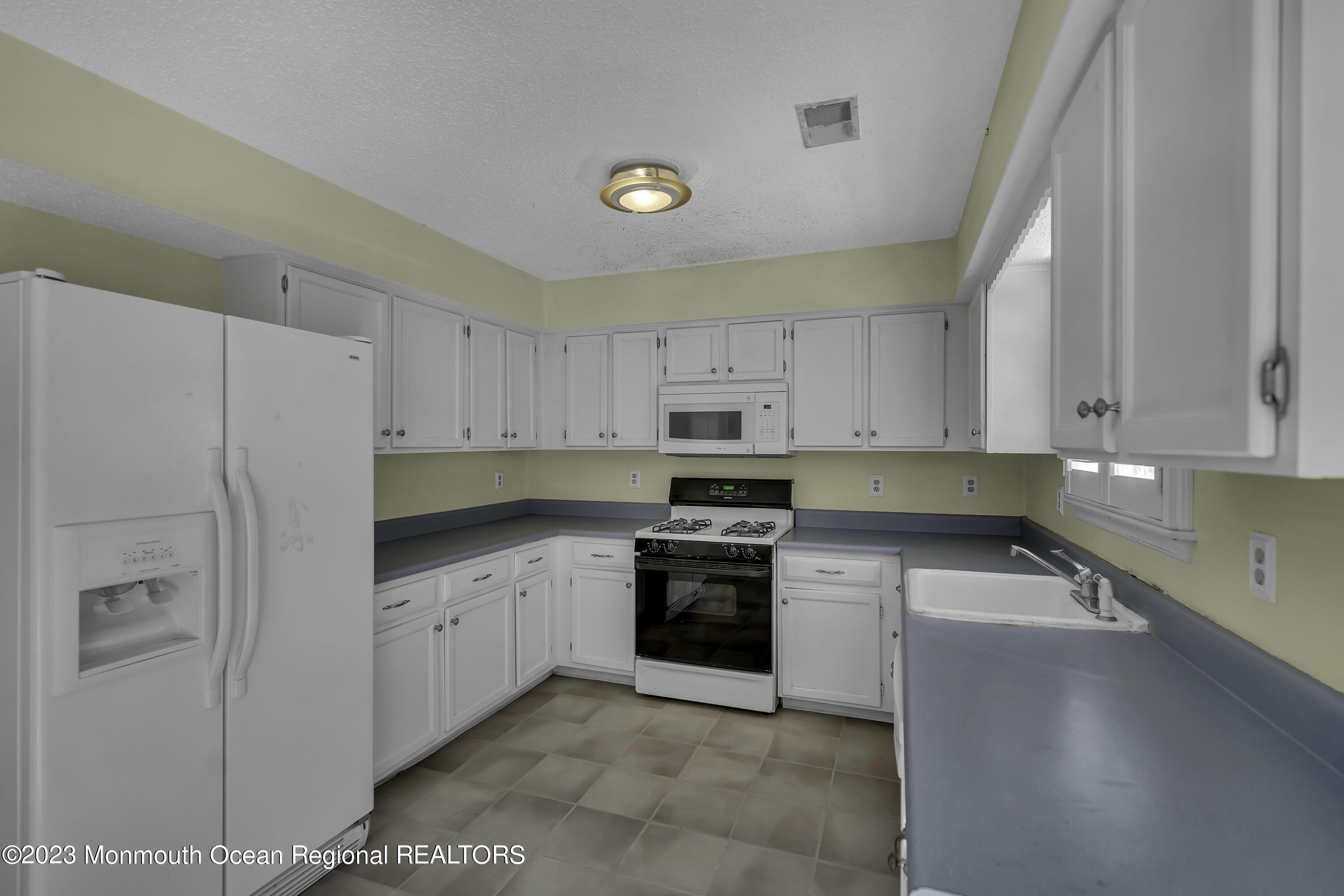 244 Down Hill Run Toms River, NJ 08755 - Photo 17 of 44 a kitchen with stainless steel appliances granite countertop a refrigerator sink and cabinets