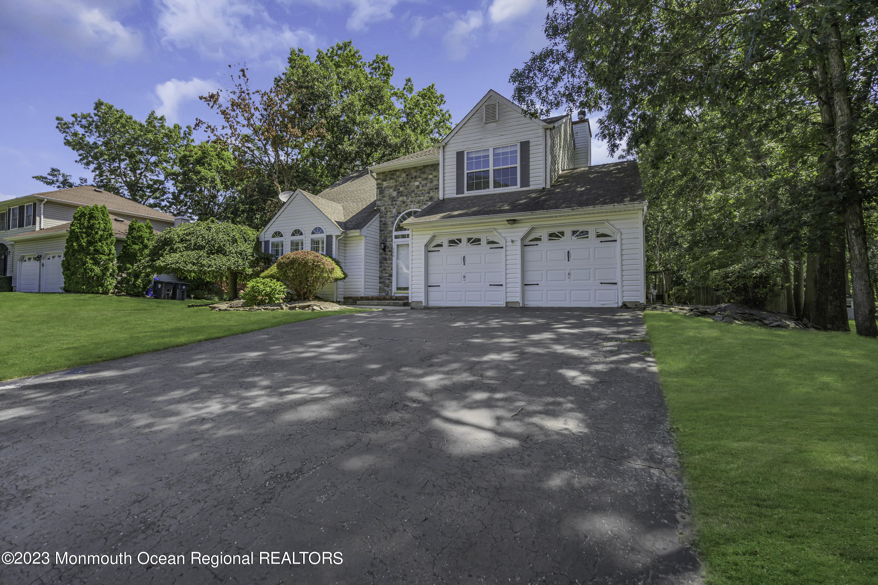 244 Down Hill Run Toms River, NJ 08755 - Photo 5 of 44 a front view of a house with a yard and garage