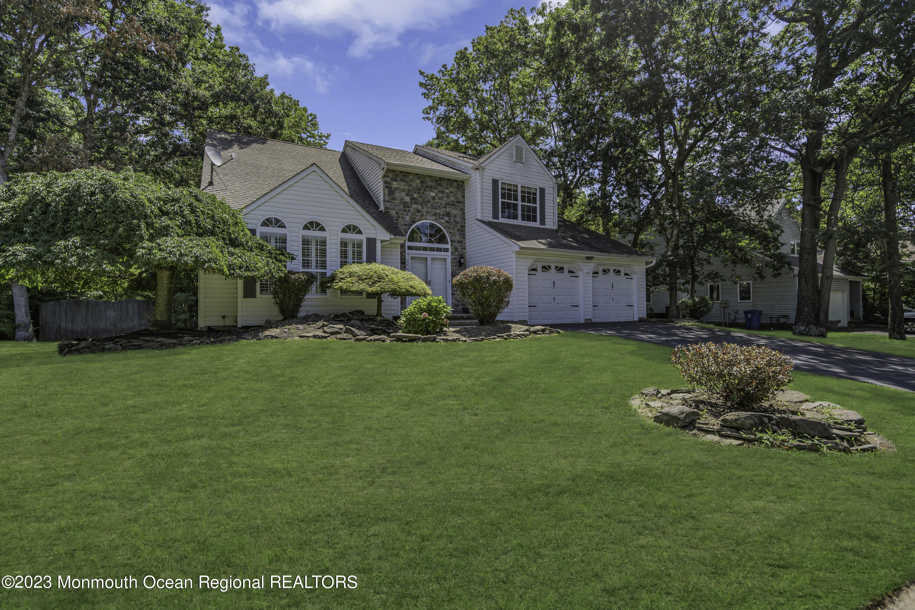 244 Down Hill Run Toms River, NJ 08755 - Photo 6 of 44 a front view of a house with a garden and yard
