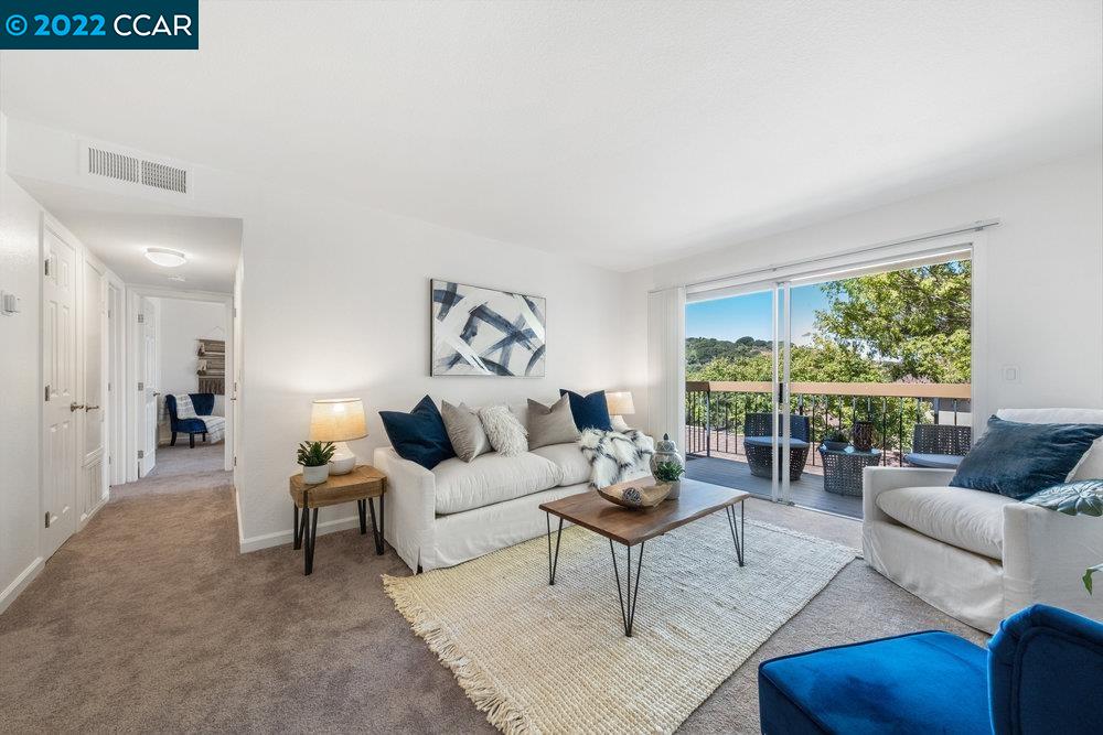 5317 Ridgeview Circle, Unit 4 El Sobrante, CA 94803 - Photo 1 of 1 a living room with furniture and a large window
