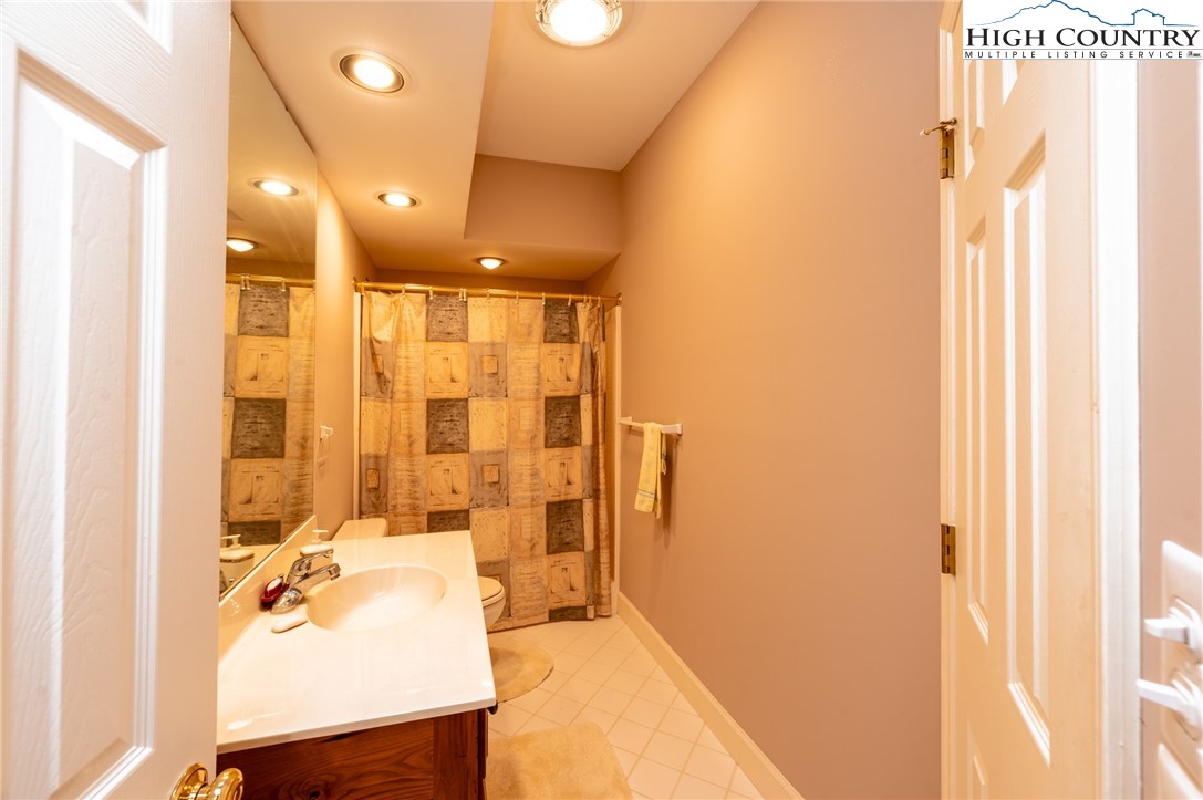 130 Prudden Lane, Unit 103 Blowing Rock, NC 28605 - Photo 20 of 36 a bathroom with a sink and mirror
