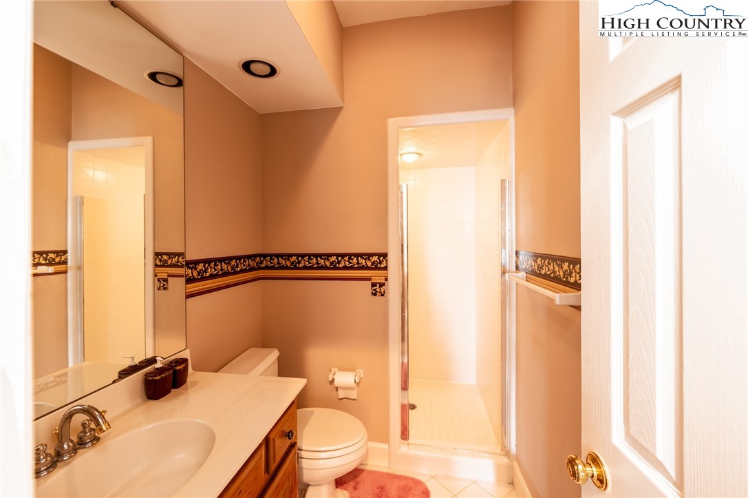 130 Prudden Lane, Unit 103 Blowing Rock, NC 28605 - Photo 21 of 36 a bathroom with a sink and a mirror