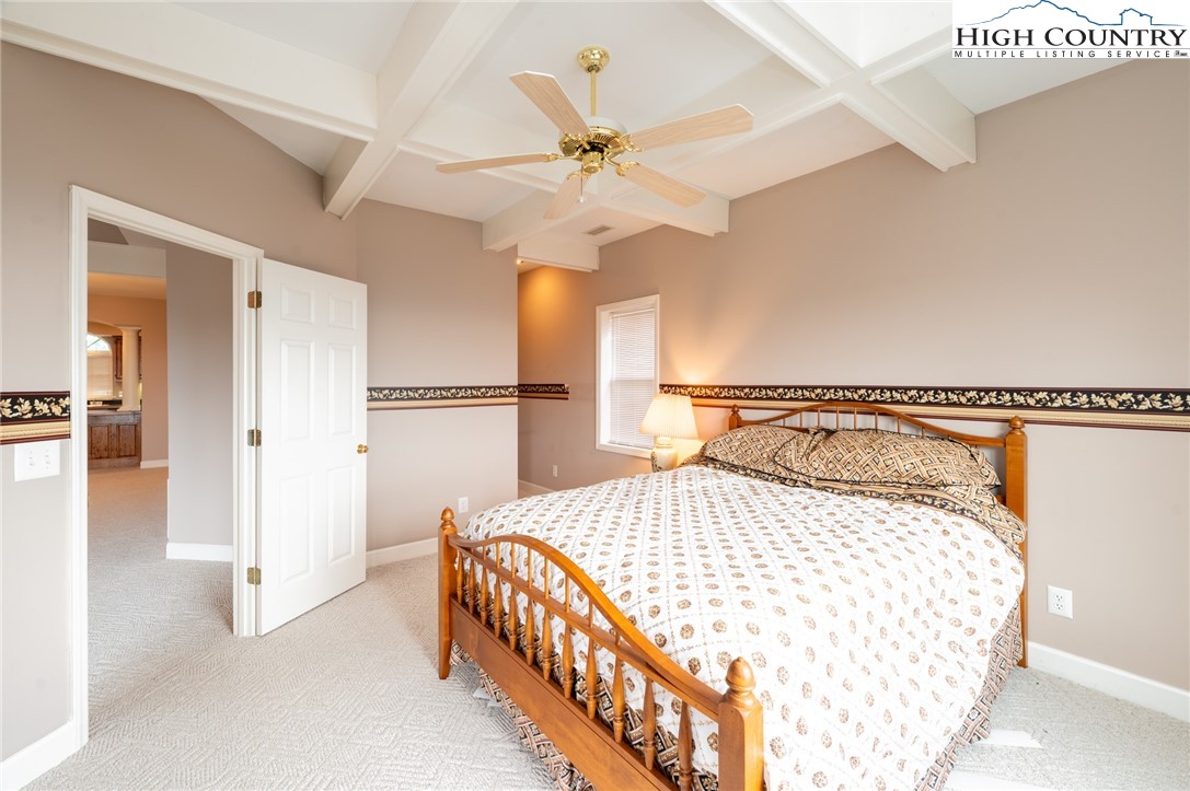 130 Prudden Lane, Unit 103 Blowing Rock, NC 28605 - Photo 22 of 36 a bedroom with a bed and a ceiling fan