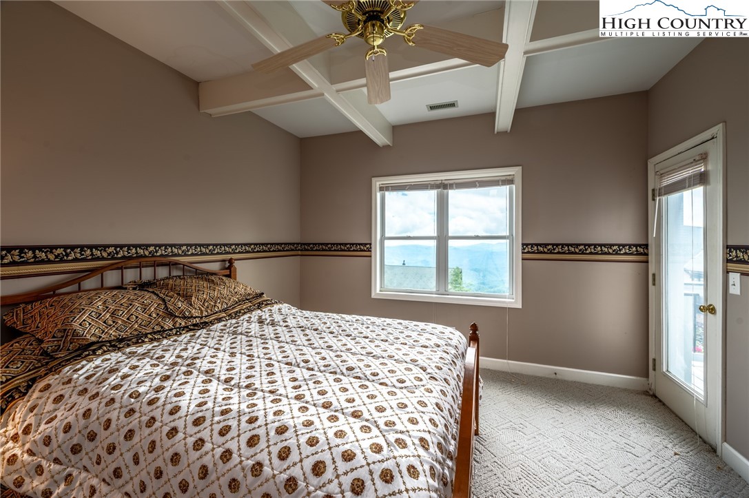 130 Prudden Lane, Unit 103 Blowing Rock, NC 28605 - Photo 23 of 36 a bedroom with a bed and a window