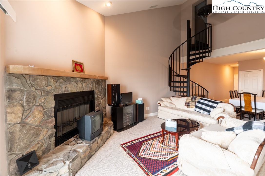 130 Prudden Lane, Unit 103 Blowing Rock, NC 28605 - Photo 25 of 36 a living room with furniture and a fireplace