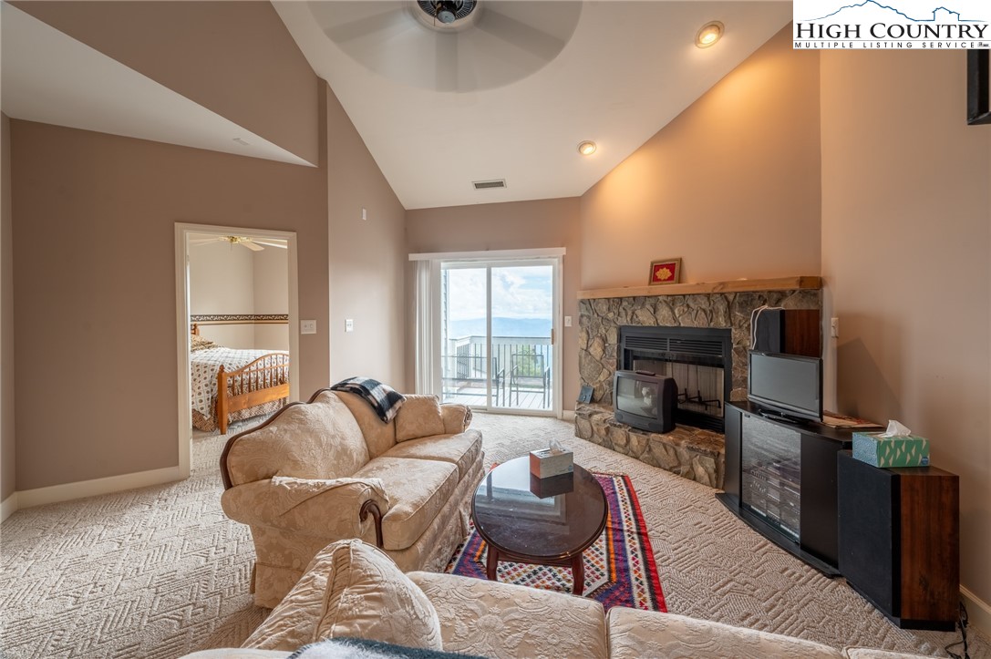 130 Prudden Lane, Unit 103 Blowing Rock, NC 28605 - Photo 26 of 36 a living room with furniture and a fireplace