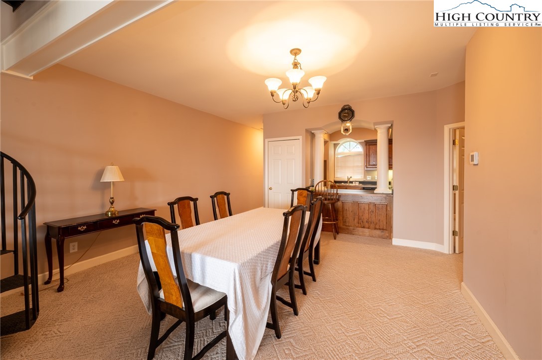 130 Prudden Lane, Unit 103 Blowing Rock, NC 28605 - Photo 27 of 36 a view of a a dining room with furniture and a chandelier