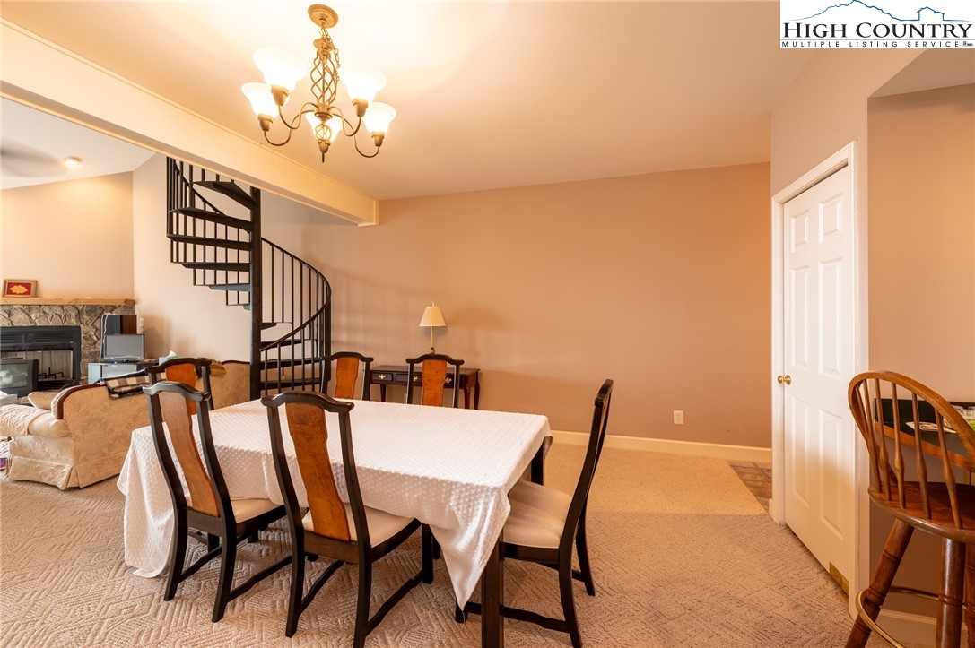 130 Prudden Lane, Unit 103 Blowing Rock, NC 28605 - Photo 29 of 36 a view of a dining room with furniture and chandelier