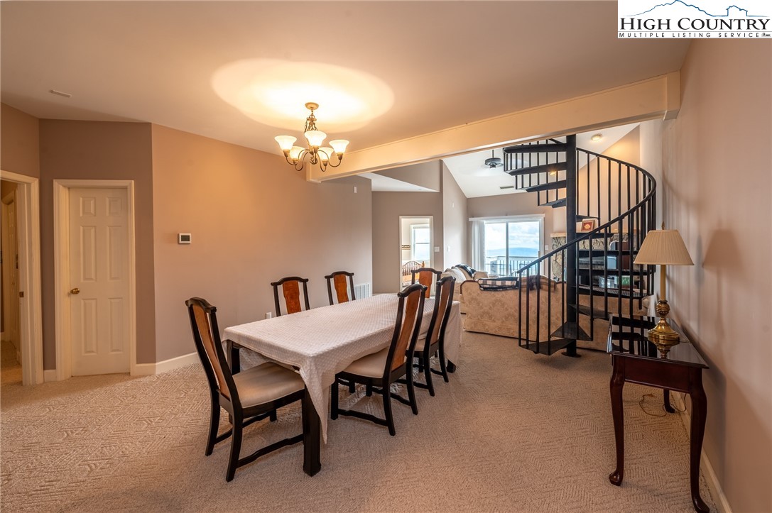 130 Prudden Lane, Unit 103 Blowing Rock, NC 28605 - Photo 32 of 36 a view of a dining room with furniture and a chandelier